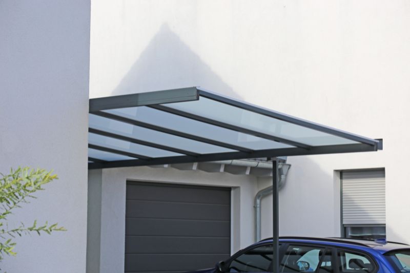 open carport attached with a car in it
